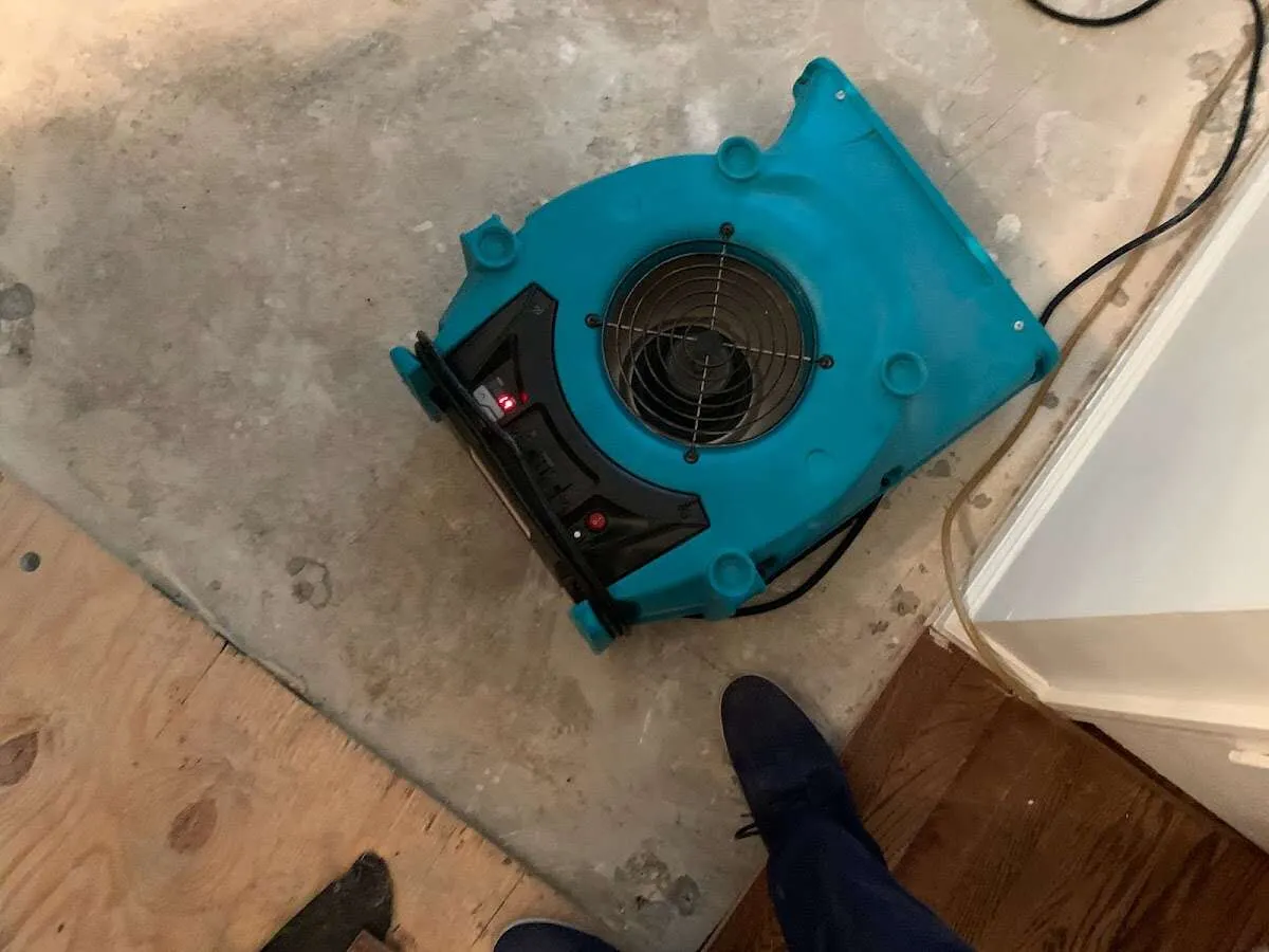 Air mover drying subfloor during Commercial Water Damage Restoration in Ocean